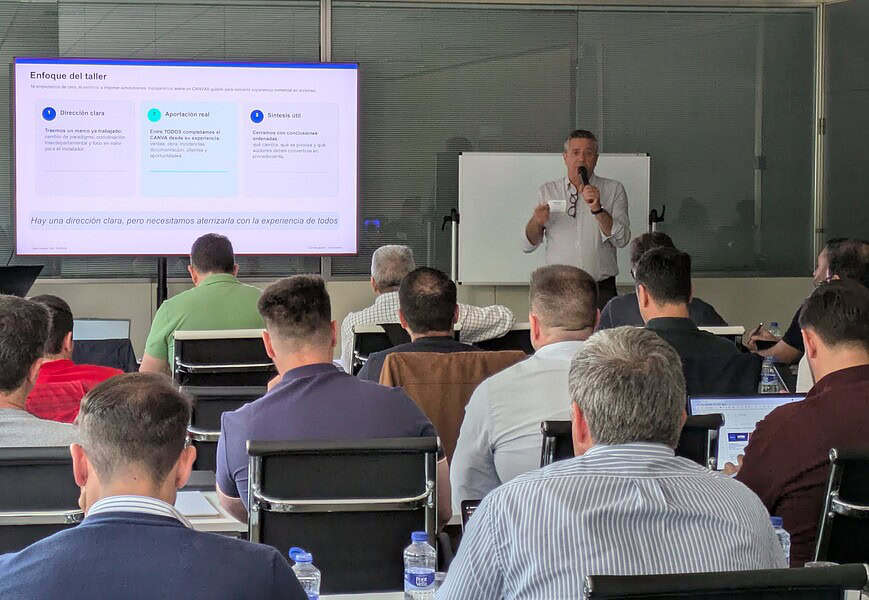 Ponente presentando el enfoque del taller de la Gia Nexus Academy ante un grupo de profesionales de Gia Group en sala de formación con pantalla de proyección